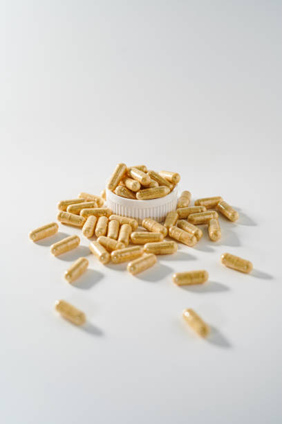 istock White medicine capsules, yellowish white pills 2152551419