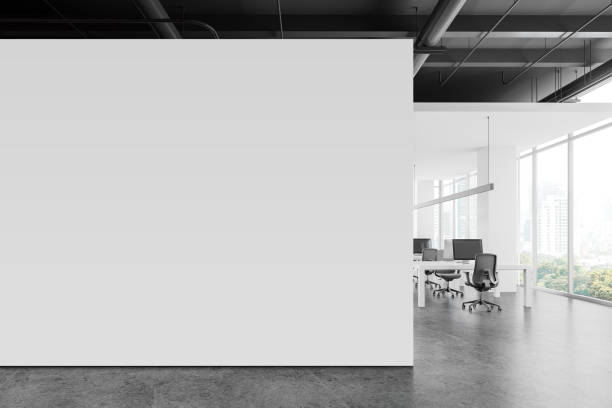 istock White coworking interior with pc computers on tables near window. Mockup wall 2152552208