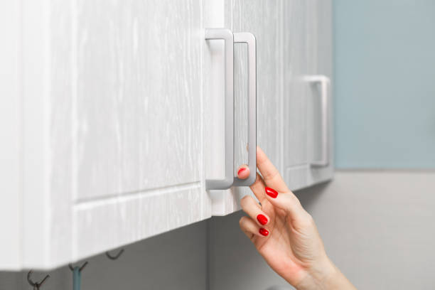 istock housewife opens kitchen wall cabinet, close-up 2152553005