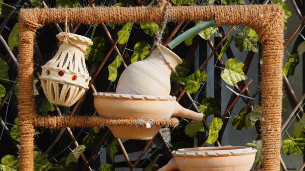 Clay vase displayed on a stone wall shelf