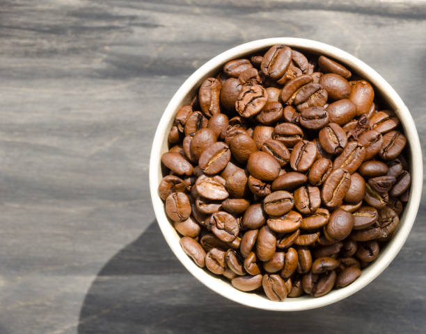 istock Coffee beans on a black background. Roasted coffee beans are ready for grinding. 2152555983