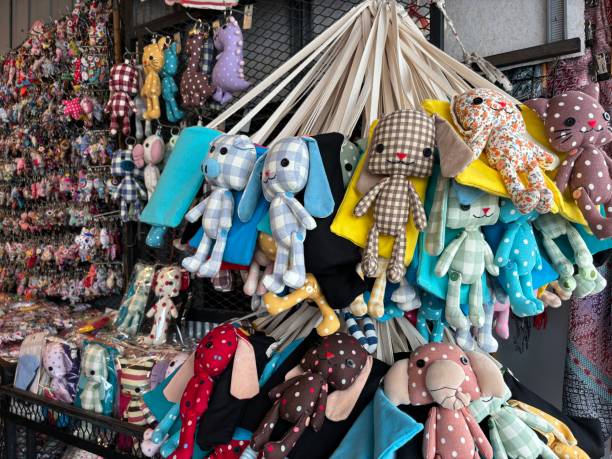 istock Colorful handmade stuffed animals displayed at a market stall 2152556553