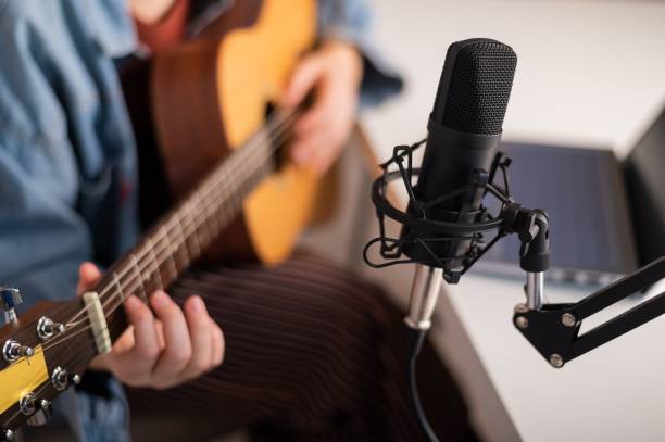 istock Faceless woman playing guitar and streaming live on laptop. 2152557514