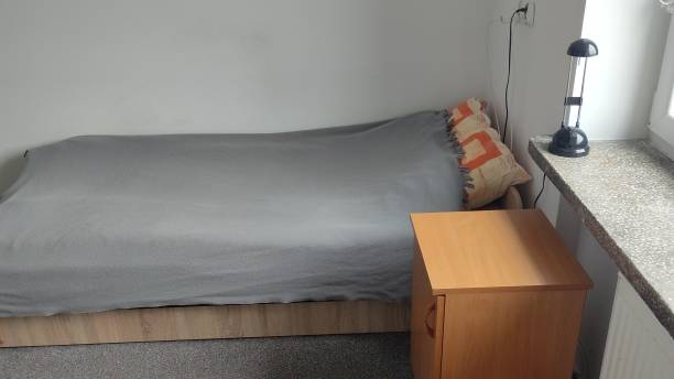 istock Bed and room in a student dormitory or inexpensive hostel. Minimalistic room interior 2152562753