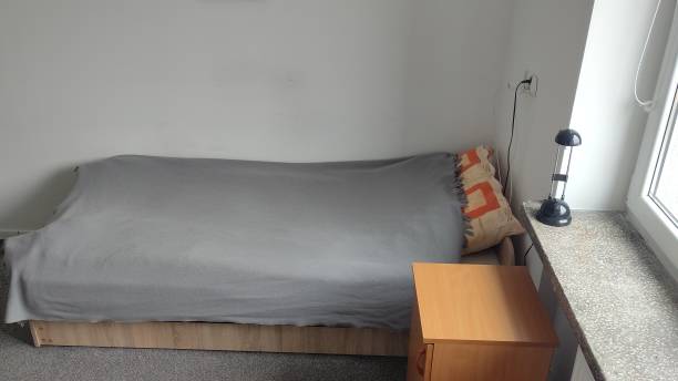 istock Bed and room in a student dormitory or inexpensive hostel. Minimalistic room interior 2152562759