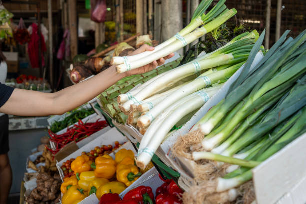 Leeks, carrots and celery tops at a vegetable stand in the Cours Saleya provencal farmers market in the Old Town of Nice, South of France