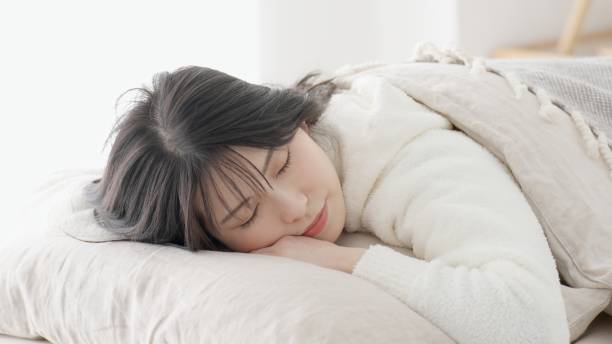 istock Asian woman sleeping on her stomach 2152565823