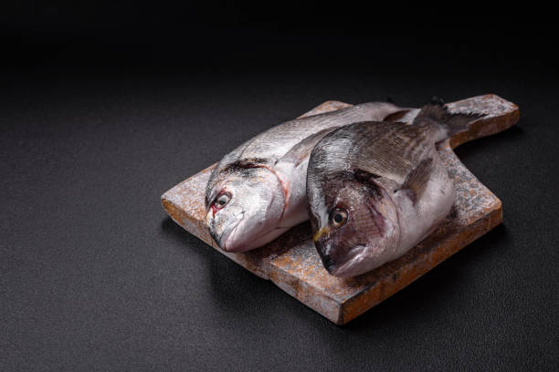 istock Whole raw dorado fish with lemon, salt, spices and herbs 2152568767