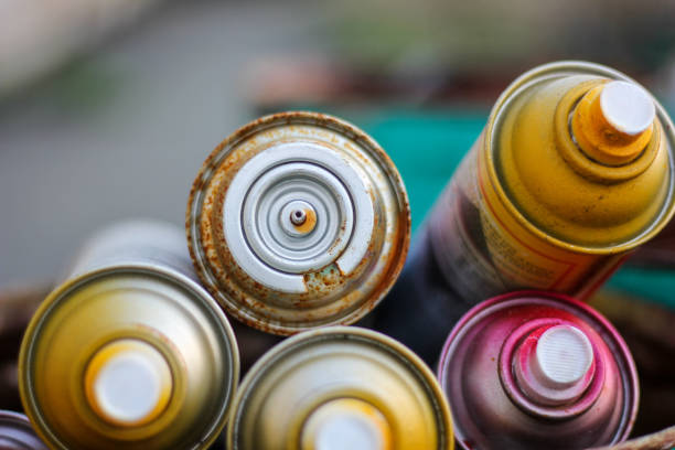Used cans of spray paint .