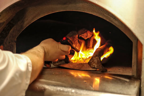 istock Hand lighting firewood in an oven 2152574576