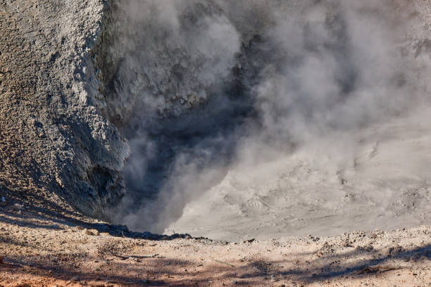 Mud volcano Mud volcano in the morning hours of early fall with steam and bubbles mud volcano yellowstone stock pictures, royalty-free photos & images