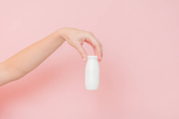 istock White bottle of probiotic yogurt for digestive system in hand. Dietary supplements for stomach 2152580233