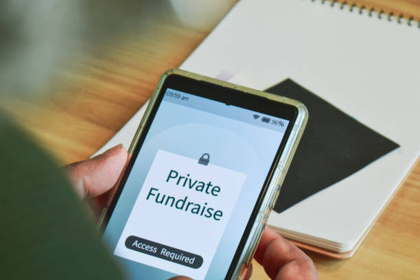 istock Man trying to access a private fundraising for donation on his mobile phone. Selective focus. 2152581814