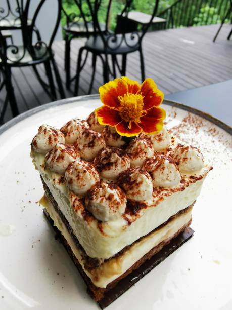 istock A slice of cheesecake with a yellow flower on top. 2152586055