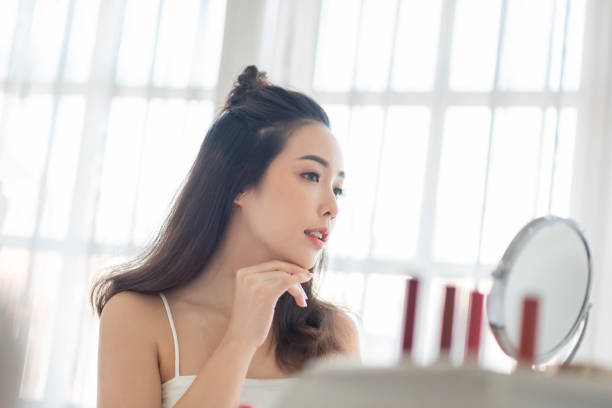 istock Asian Female looking at makeup mirror 2152594718