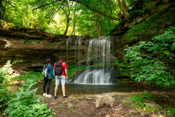 istock Young couple in front of waterfall 2152594753