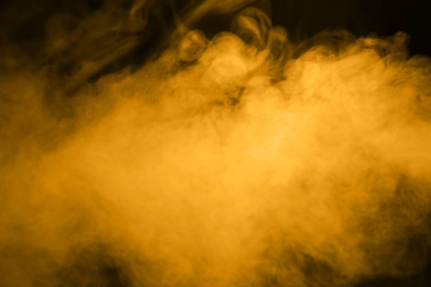 Golden smog on black background. Studio photo.