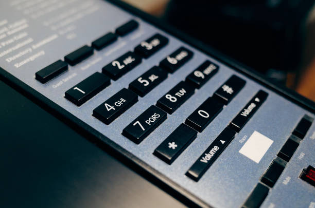 Keyboard of grey telephone by a large plan