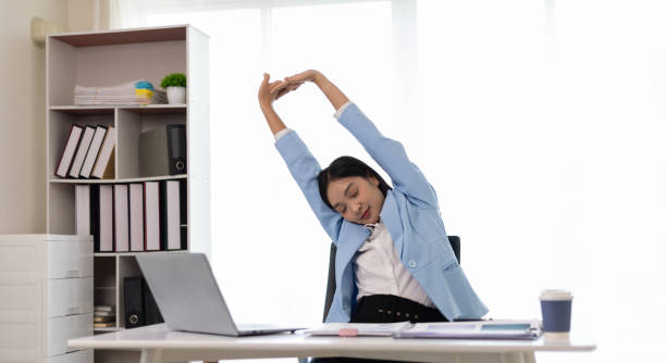 istock Woman working in office stretching during break to relieve fatigue. 2152601932