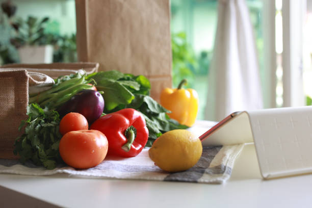istock An eco-friendly reusable shopping bag filled with multi-colored fresh vegetables and groceries on the kitchen counter at home, representing the concept of zero waste and a sustainable lifestyle 2152604599