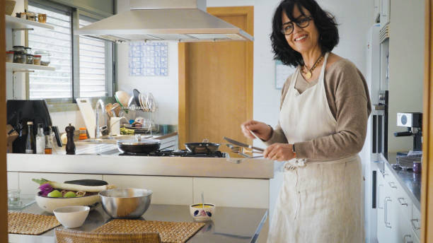 istock Smiling woman carrying cutlery to table for lunch 2152608785
