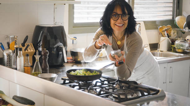 istock Smiling Woman cooking her diet food 2152608823