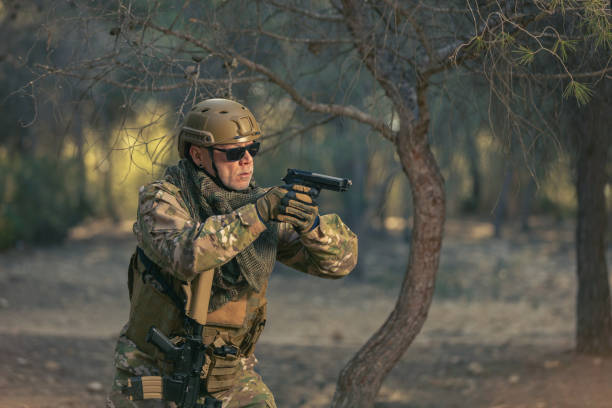 airsoft soldier  training in the forest at sunset