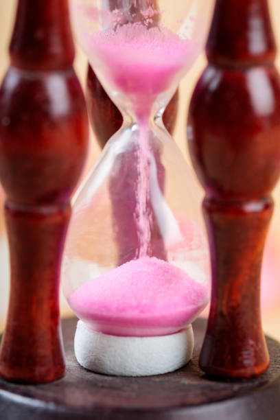 istock Pink Sand Hourglass Flowing, Time for Sustainability Concept, Close Up 2152618148
