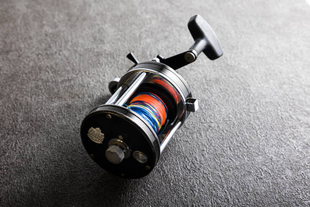 Two big fishing reels on a boat in the ocean.  These reels are used to catch big game fish such as Mahi-mahi, dorado, tuna, sailfish, swordfish sharks and marlin.  They are used in tropical and cold water oceans.
