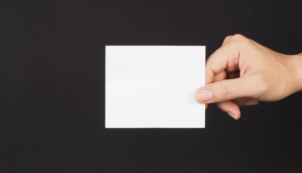 istock Hand holding white blank card on Black background. 2152626511