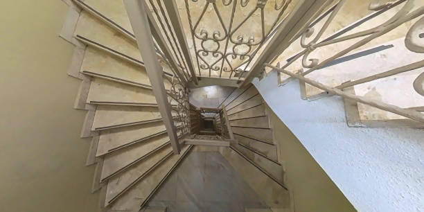 Rectangular spiral stairway made out of white marble