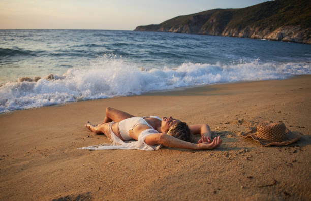 istock Beautiful woman on the beach at sunset 2152630721