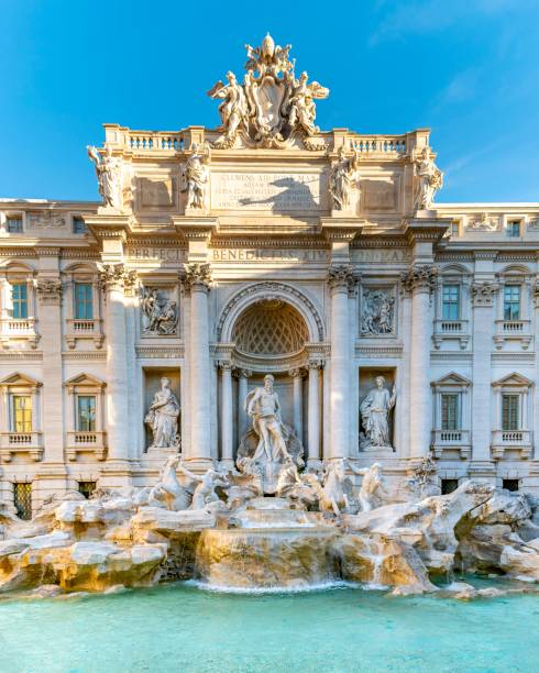 Trevi Fountain, Rome - Baroque Masterpiece The Trevi Fountain in Rome, Italy, showcasing its intricate baroque sculptures and clear turquoise waters under a bright blue sky. neptune roman god stock pictures, royalty-free photos & images