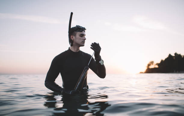 istock Spearfisherman checks spearhead 2152635861
