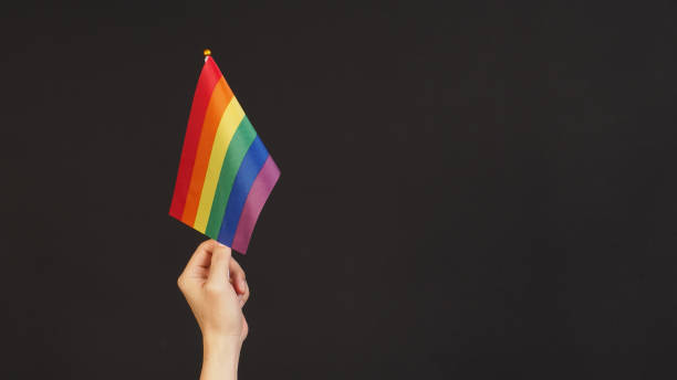istock Hand is hold Rainbow pride flag on black ackground. 2152637499