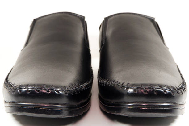 Formal black shoes pairing together isolated on white background close-up front view