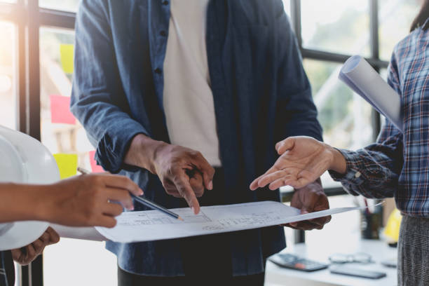 istock Architect or engineer are meeting to discuss house designs, modify plans for construction projects, and additions according to customer needs. 2152639823