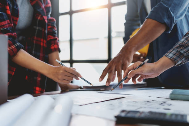 istock Architect or engineer are meeting to discuss house designs, modify plans for construction projects, and additions according to customer needs. 2152639825