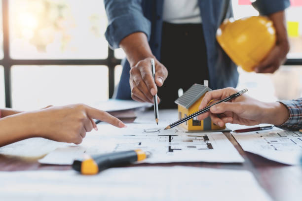 istock Architect or engineer are meeting to discuss house designs, modify plans for construction projects, and additions according to customer needs. 2152639830