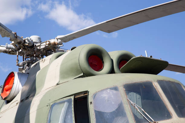 Military helicopter on the landing pad at the base.