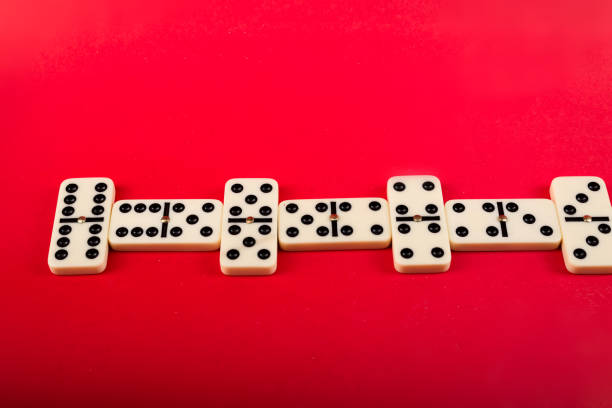 Dominoes with red background, copy space and various angles, board games concept.