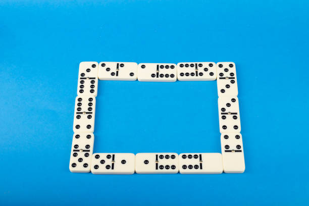 Dominoes with blue background, copy space and various angles. White Bones Board Game.