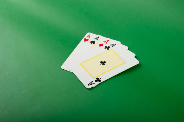 Playing card for poker and gambling, four aces. Isolated on green background.