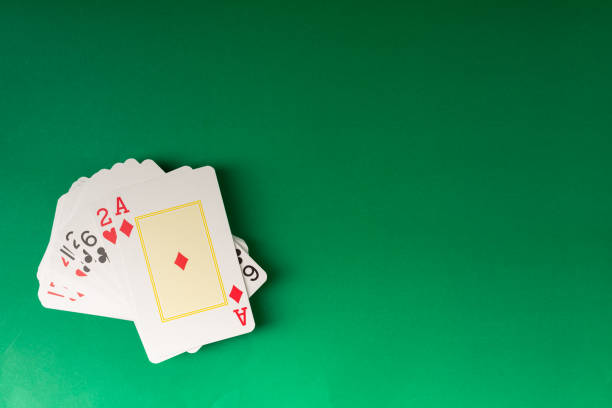 Playing cards isolated on green background. Gambling.