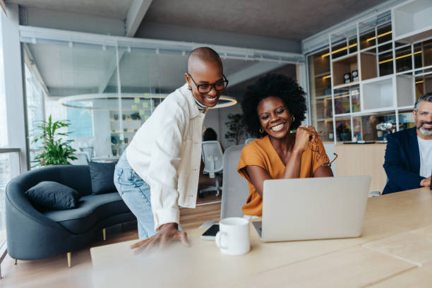 istock Successful businesswomen collaborating and working with technology in a vibrant office environment 2152643705