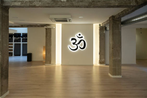 Spacious loft with Om symbol lighting and minimalist design.