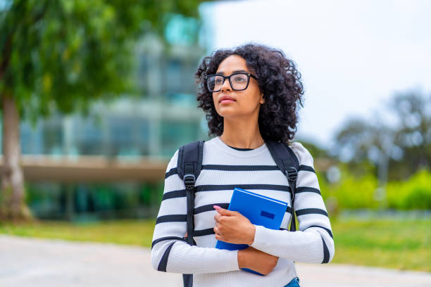 istock Dreamy latin student looking up in the university campus 2152646992