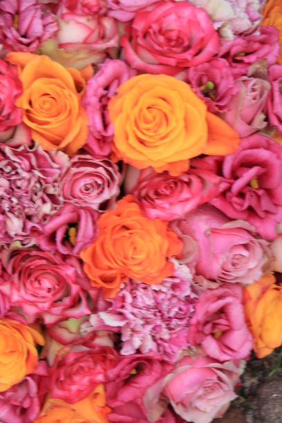 Wedding flowers: roses, carnations and listianthuis in various shades of pink and orange