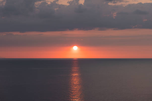 Sea or ocean sunset. Beautiful photo of a sunset setting on the sea horizon.