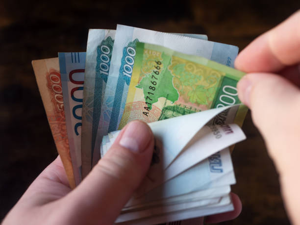 istock Counting a Variety of Russian Banknotes in Hand 2152652484